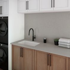 a kitchen with a sink, washer and dryer next to eachother