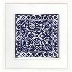 a blue and white square with an intricate design on it's side, framed in a white frame