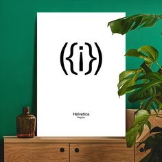 a poster with the letter kj on it next to a plant in a room