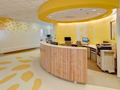 an office with yellow and white decor on the walls