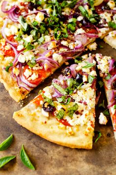 a pizza topped with lots of toppings on top of a wooden cutting board