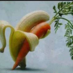 there is a banana and carrot on top of each other