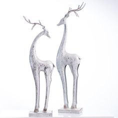 two metal giraffes standing next to each other