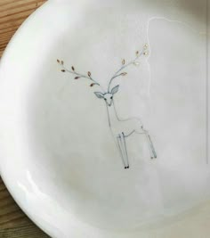 a white plate with a drawing of a deer on it