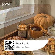 a table topped with pie next to a window filled with pumpkins and other items