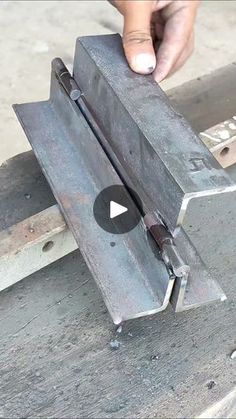 a person is working with metal parts on a bench