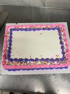 a birthday cake with sprinkles on it is sitting on a counter top