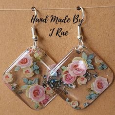 two square shaped glass earrings with flowers on them