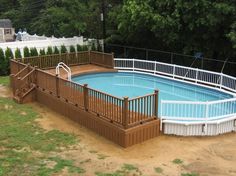 an above ground pool surrounded by wooden decks