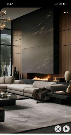 a large living room with modern furniture and fireplace