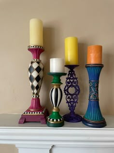 candles are lined up on top of a mantle