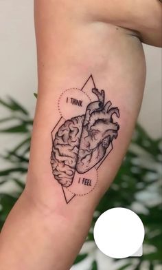 a tattoo on the leg of a woman with a heart and brain