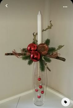 a candle and some ornaments in a vase