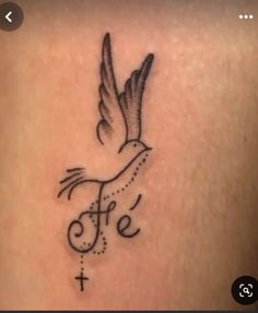 a small tattoo on the back of a woman's shoulder that reads, life