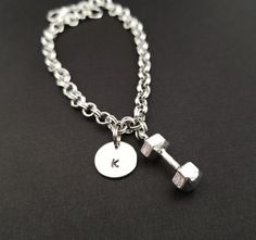 Personalized Antique Silver Dumbbell Bracelet!  A three dimensional dumbbell charm on a lovely chain bracelet makes the perfect gift for you or your favorite fitness lover.The dumbbell bracelet charm is made from zinc alloy and measures 22 mm by 8 mm.  The bracelet is high quality zinc alloy and measures 8.5".  The fitness bracelet can be personalized with a .5" silver plated disc stamped with the initial of your choice.  The charm and initial disc are connected to the bracelet with sturdy split Adjustable Stainless Steel Charm Bracelet For Personalized Gift, Customizable Adjustable Stainless Steel Charm Bracelet, Adjustable Nickel-free Charm Bracelet Gift, Antique Silver Nickel-free Charm Bracelet For Gift, Bible Verse Bracelet, Mom Necklace Personalized, Adjustable Vintage Nickel-free Charm Bracelet, Fitness Jewelry, Bracelet Initial