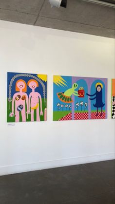 three paintings hang on the wall next to each other