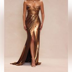 a woman in a gold dress posing for the camera