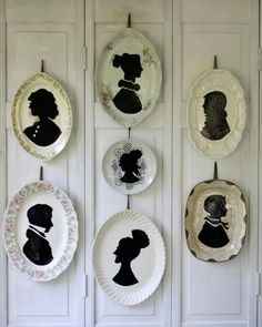 plates with silhouettes hanging on the wall