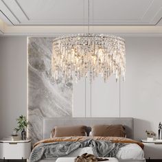 a bedroom with a large bed and a chandelier hanging from the ceiling above it