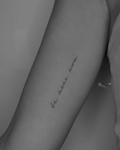 a woman's arm with the word love written in cursive writing on it