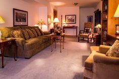 a living room filled with furniture and lamps