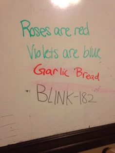 a white board with writing on it in a bathroom stall that reads roses are red violets are blue garlic bread blink - bye