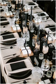 the table is set with black and white place settings