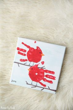 handprinted red birds on a branch with the words super - sweet cardinal handprint