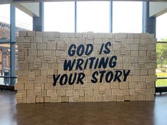 a cardboard sign that says god is writing your story