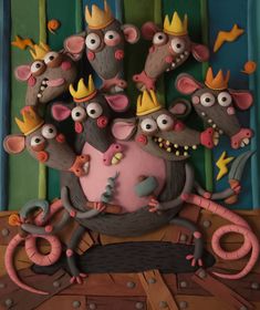 a group of mouses with crowns on top of them sitting in front of a wall