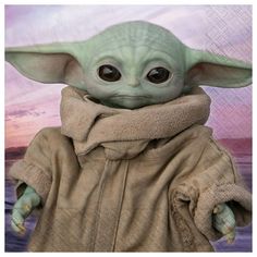 the child yoda doll is posed in front of a backdrop with clouds and sunsets