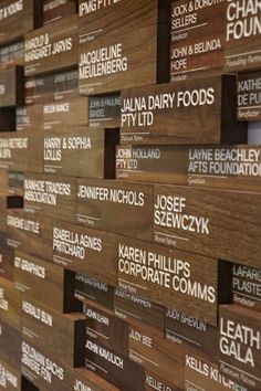 the wall is made up of many different types of business cards on wood planks