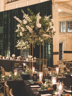 the tables are set up with candles and centerpieces for an elegant wedding reception