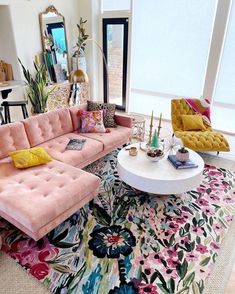 a living room filled with lots of furniture and decor on top of a colorful rug