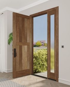 an open wooden door in a white room with wood flooring and large windows looking out onto a green field