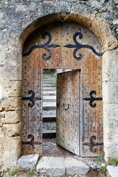 an old wooden door with iron work on it