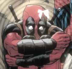 the deadpool character is holding his arms crossed