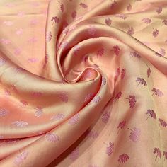 an image of a pink and purple fabric with flowers on it's side, close up