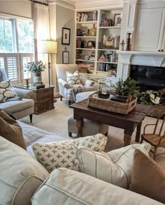 a living room filled with furniture and a fire place in the middle of a room