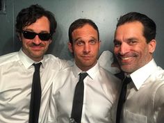 three men in white shirts and black ties posing for a photo with one man wearing sunglasses