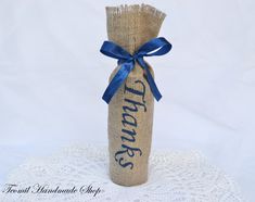 a burlock wrapped wine bottle sitting on top of a doily