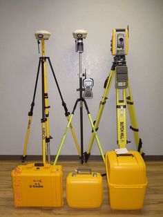 three yellow suitcases sitting on top of a hard wood floor next to each other