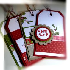 three tags with the number twenty five on them are shown in red, green and white