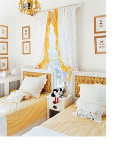 two twin beds in a bedroom with yellow and white bedding, one has a stuffed animal on the nightstand