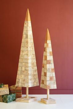 two wooden christmas trees sitting next to each other