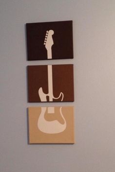 three square paintings with guitars on them hanging on the wall