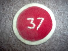 a red and white circle with the number 37 on it's side is shown