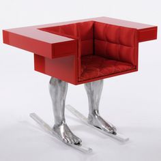 a red chair with legs that are shaped like a dog