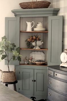 an antique corner cabinet is painted in blue and green with the words primitive antiques written above it