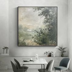 a painting hanging on the wall above a dining room table with four chairs and a vase